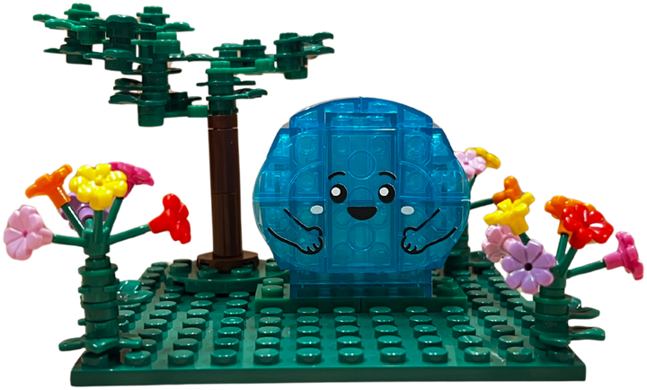 The BRAVE MiniBlock: a turquoise BRAVE built from toy blocks, with a tree and flowers